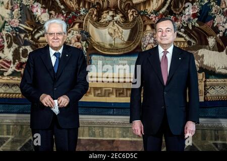 Rome, Italy. 13th Feb, 2021. Italian President Sergio Mattarella (L) and Prime Minister Mario Draghi pose for a photo at the Quirinal presidential palace in Rome, Italy, Feb. 13, 2021. The Italian government formed by newly-appointed Prime Minister Mario Draghi, who was the former chief of the European Central Bank (ECB), was officially sworn in on Saturday. (Pool via Xinhua) Credit: Xinhua/Alamy Live News Stock Photo