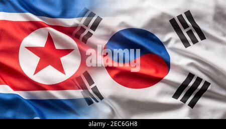 Flags of North and South Korea blowing in the wind. Stock Photo
