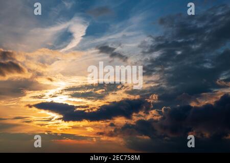 Fantastic view of cloudy sky. Dramatic and picturesque sunset scene. The weather changes, the rain clouds go away, the sun appears through clouds Stock Photo