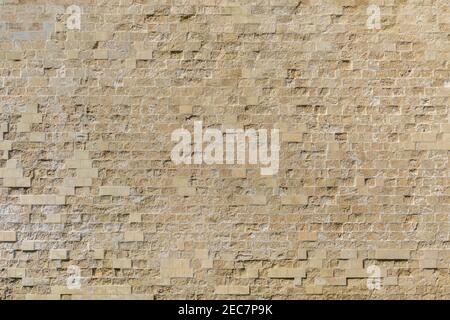 Masonry wall of ancient stone blocks of limestone. Background texture of old fortress brick wall. Texture background for graphic design Stock Photo