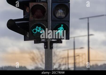 Green safe bicycle and woman pedestrian signal. Many traffic lights with female figure shape are in one of avenue in Vilnius, Lithuania. Concept of eq Stock Photo