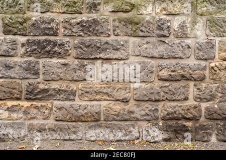 Texture pattern of a rough stone wall with big rectangle rocks. Organic grunge sand stone structure. Stock Photo