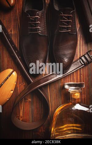 Men's brown leather shoes and belt on wooden background Stock Photo