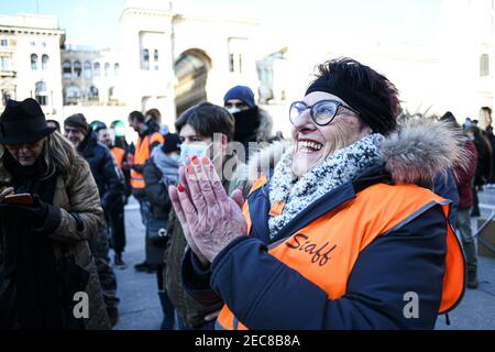 Milan, Italy. 13th Feb, 2021. A supporter of the Orange Vests (Gilet Arancio) movement gestures during a rally in Piazza Duomo in Milan, Italy on 13 February 2021 Credit: Piero Cruciatti/Alamy Live News Stock Photo