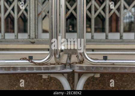 Campos, Spain; february 12 2021: Bar closed due to Spanish governmental measures to control the Coronavirus pandemic.Close-up of tables stacked outsid Stock Photo