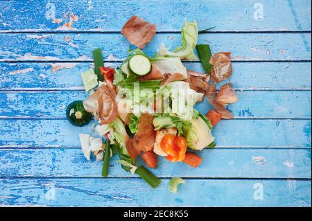 organic waste from vegetables on blue background, view from top Stock Photo