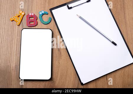 Online education flat lay photo. Distance learning concept. Computer digital tablet white empty space for your advertisement, ABC, white sheet on Stock Photo
