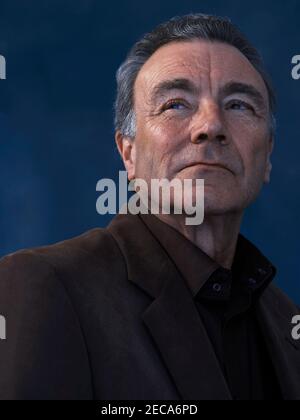 head and shoulders portrait of middle aged man looking into the distance Stock Photo