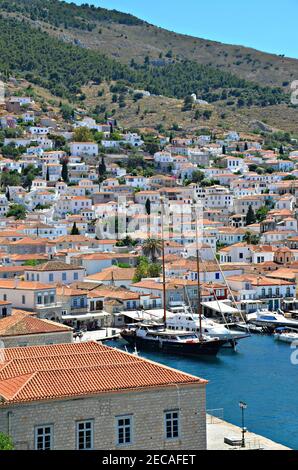 Landscape with panoramic view of Hydra port with the traditional fishing boats and the Neoclassical architecture in Hydra island, Attica Greece. Stock Photo