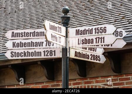 Signpost with directions showing distance in kilometres to different Europe capital cities from Brussels, Belgium Stock Photo