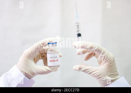 Development and creation of a coronavirus vaccine COVID-19. Coronavirus Vaccine concept in hand of doctor white vaccine jar. Vaccine Concept of fight Stock Photo