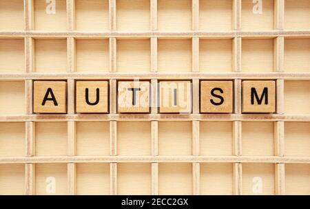 Word Autism made with wooden cubes. Concept about autism spectrum disorder ASD. Stock Photo