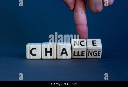 Challenge or chance symbol. Businessman turns cubes and changes the word 'challenge' to 'chance'. Beautiful grey background, copy space. Business and Stock Photo
