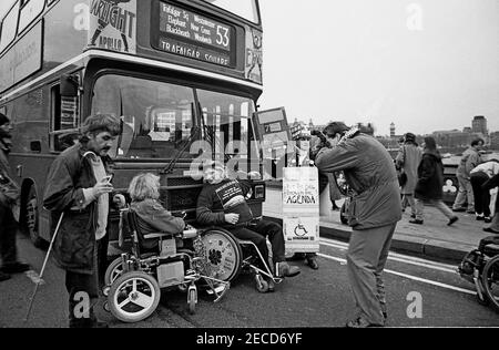 Wheelchair users Barbara Lisicki and Alan Holdsworth from DAN (Disabled Action Network) handcuff themselves to a London bus on Westminster Bridge, London in  February 1995 as part of a series of protests about lack of disabled persons access to public transport, in the lead up to the Disability Discrimination Act being debated in Parliament. Stock Photo