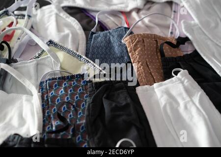 Different anti-covid fabric face masks washable laying on a table. Stock Photo
