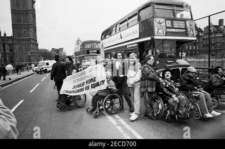 Wheelchair users from DAN (Disabled Action Network) handcuff themselves to a London bus on Westminster Bridge, London in  February 1995 as part of a series of protests about lack of disabled persons access to public transport, in the lead up to the Disability Discrimination Act being debated in Parliament. Stock Photo