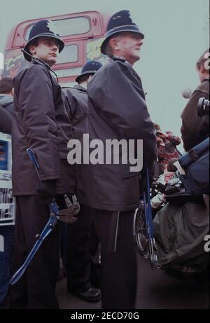 Police with bolt croppers prepare to remove wheelchair users from DAN (Disabled Action Network) who have handcuffed themselves to a London bus on Westminster Bridge, London in February 1995 as part of a series of protests about lack of disabled persons access to public transport, in the lead up to the Disability Discrimination Act being debated in Parliament. Stock Photo