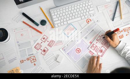 Website designer creates a sketch application. Developing a project drawing an interface mockup. Stock Photo