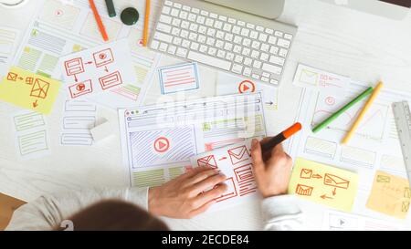 Website designer creates a sketch application. Developing a project drawing an interface mockup. Stock Photo