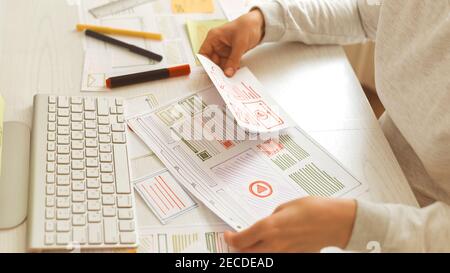 Website designer creates a sketch application. Developing a project drawing an interface mockup. Stock Photo