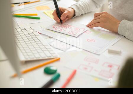Website designer creates a sketch application. Developing a project drawing an interface mockup. Stock Photo