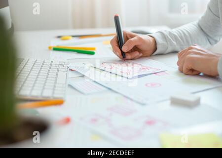 Website designer creates a sketch application. Developing a project drawing an interface mockup. Stock Photo