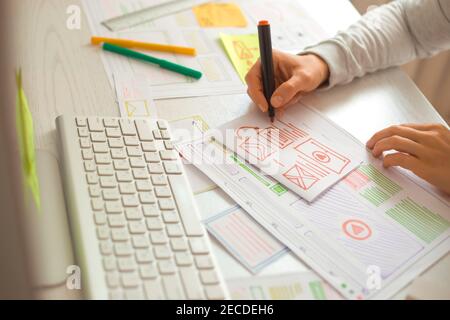 Website designer creates a sketch application. Developing a project drawing an interface mockup. Stock Photo