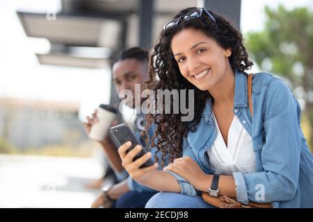 smiling young woman checking table of city traffic online Stock Photo