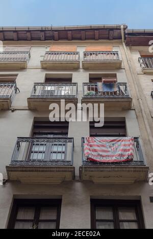 House facade with flag Athletic Bilbao in the old town of Bilbao, Spain Stock Photo