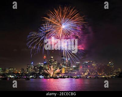 City of Sydney skyline and Harbour waterfront at midnight during New Year fireworks display show. Stock Photo