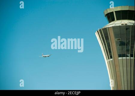 An Air China aircraft flies past the Air traffic Control tower on departure on a sunny, blue sky, pollution-free day at Beijing Capital Airport, in the Shunyi district of the Chinese capital, Beijing, China, PRC. © Time-Snaps Stock Photo