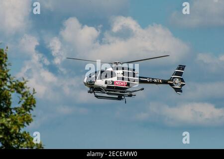 Vordingborg Denmark - June 26. 2016: Danish tv2 News helicopter in the air filming Stock Photo