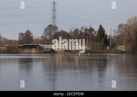 Harefield, UK. 13th February, 2021. Ice is pictured on the surface of HOAC lake in the Colne Valley. The current cold spell is expected to be replaced by milder conditions after tomorrow. Credit: Mark Kerrison/Alamy Live News Stock Photo