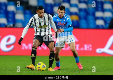 Juventus's Brazilian defender Alex Sandro (L) challenges for the ball with SSC Napoli's Mexican striker Hirving Lozano   during the Serie A football match between SSC Napoli and   Juventus FC  at the Diego Armando Maradona Stadium, Naples, Italy, on 13 February  2021 Stock Photo