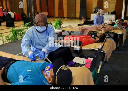 Blood donor at donation, transfusion. Close up right arm of a business man receiving blood in hospital. Healthcare and charity. Pekalongan, December 1 Stock Photo