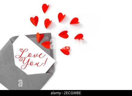 Red paper hearts and Valentine card on white background Stock Photo