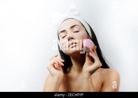 happy woman using deep cleansing face tool Stock Photo