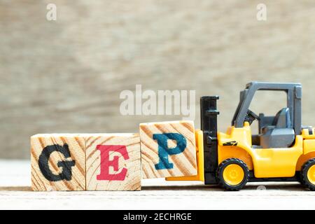 Toy forklift hold letter block p to complete word GEP (abbreviation of good engineering practice) on wood background Stock Photo