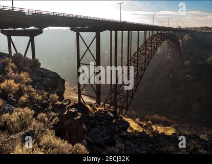Early morning sun burns off the fog in the Snake River Canyon below the Perrine Bridge at Twin Falls Stock Photo
