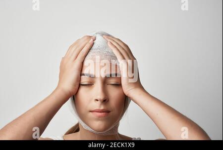 woman's bandaged head injury health problem medicine Stock Photo