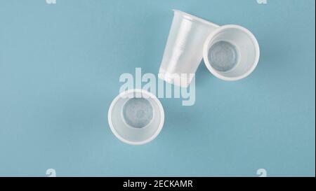 white plastic cups on a blue background Stock Photo