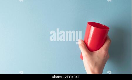 red glass in hand on a deep background Stock Photo