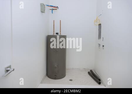Household appliances with boiler and pipes of the heating system of a house under construction Stock Photo