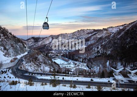 Cableway with funicular in the winter mountains at near Medeo Skate arena at sunrise in Almaty, Kazakhstan Stock Photo