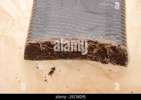 broken into several parts pieces of chocolate from cocoa, natural food from cocoa, pieces of large natural real chocolate, sugar, cocoa butter  Stock Photo