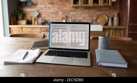 Close up modern laptop standing on wooden table with notebooks Stock Photo