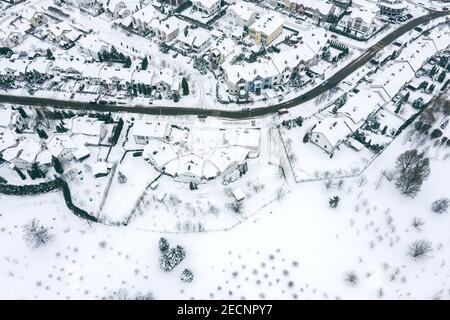 residential neighborhood on a white snowy landscape after snowstorm. aerial photography with drone Stock Photo