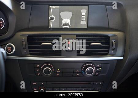 GRODNO, BELARUS - JUNE 2020: BMW X3 II F25 xDrive Premium car interior backup parking assistant system with sensors on screen with start stop engine Stock Photo