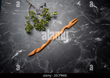handcraft wooden fork on black marble Stock Photo