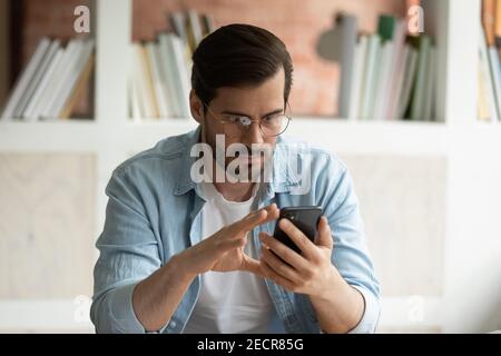 Focused man use cellphone reading news online Stock Photo